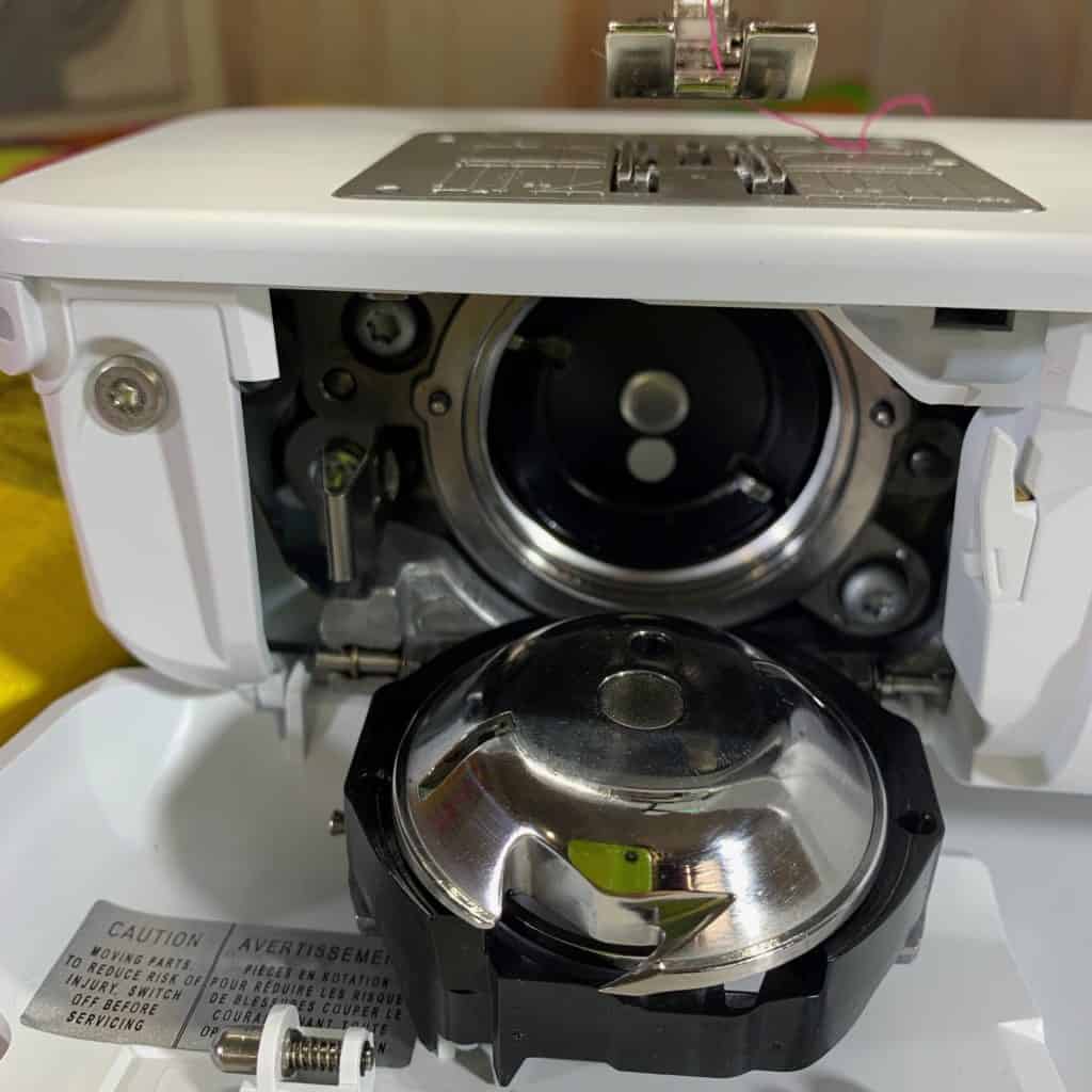How do I insert the bobbin case in the machine?